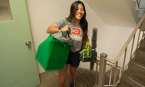a Carroll University student carrying bags.