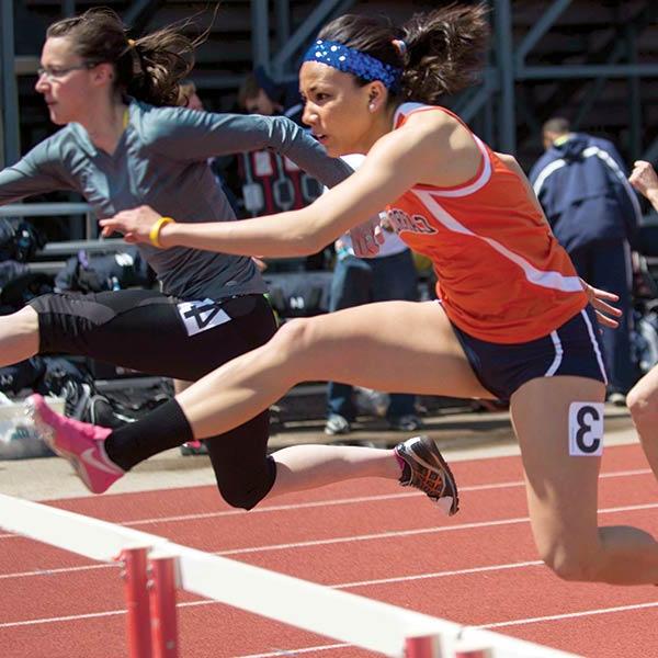 Female student-athlete participating in a hurdles race