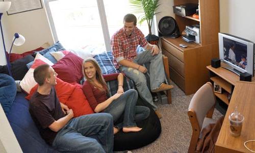Photo of three students watching TV in dorm
